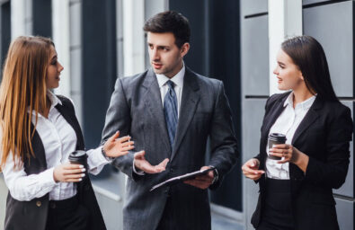 Three people in business attire talking